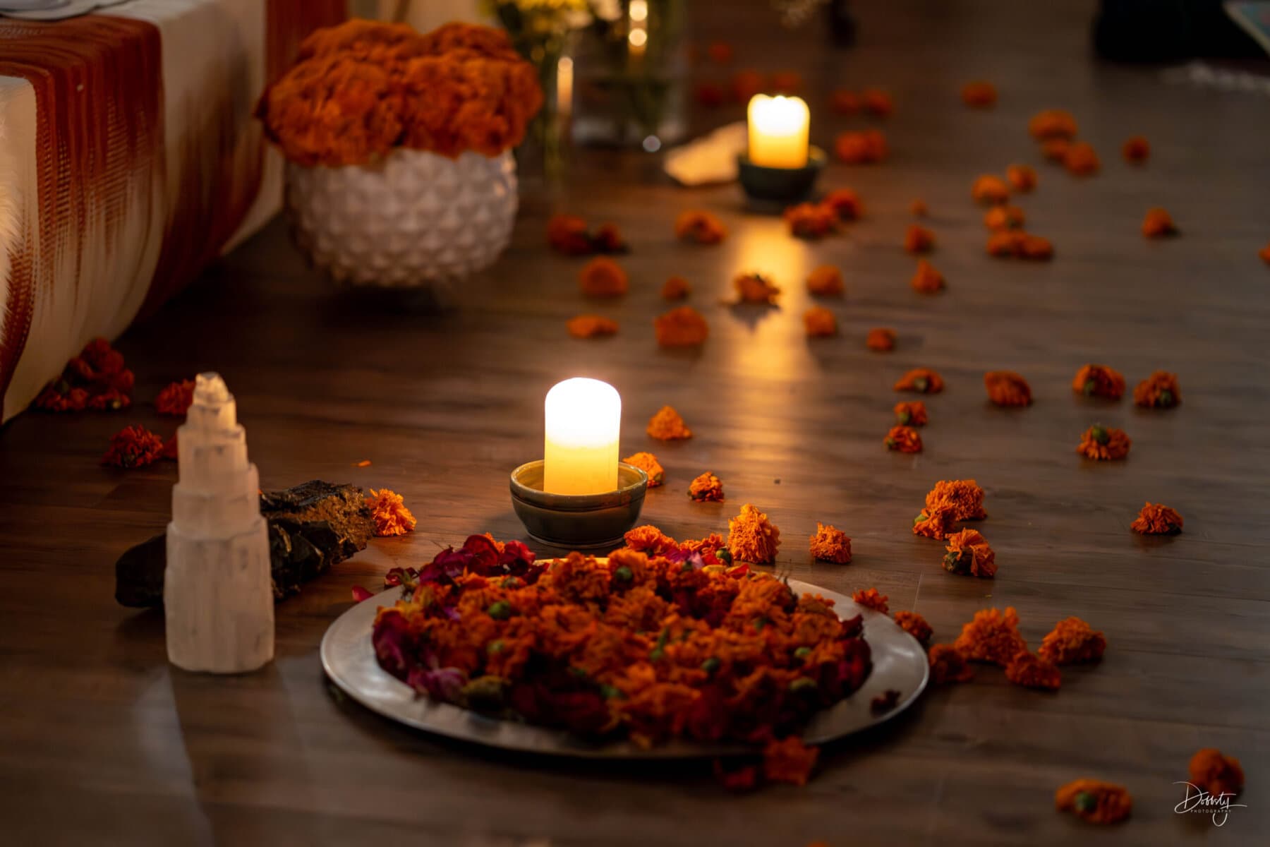 Candles and scattered marigold petals create a serene setting, perfect for yoga and meditation at The MataJi Sanctuary.