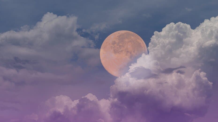 Full moon and cloudy sky with purple hues, creating a serene and mystical atmosphere.