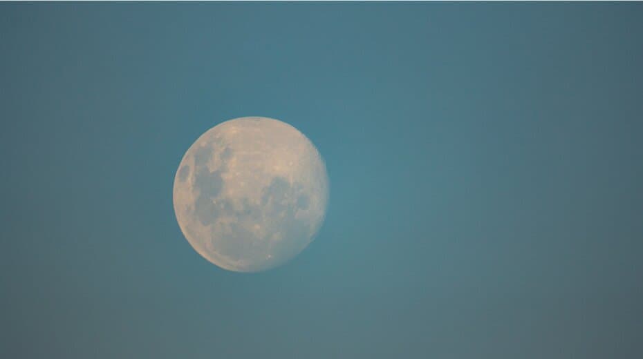 Full moon against a clear blue sky.