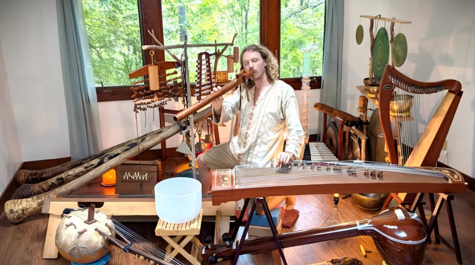 A musician plays various traditional instruments in a tranquil space, surrounded by natural light and greenery.